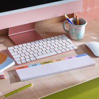 notepad in front of keyboard and computer